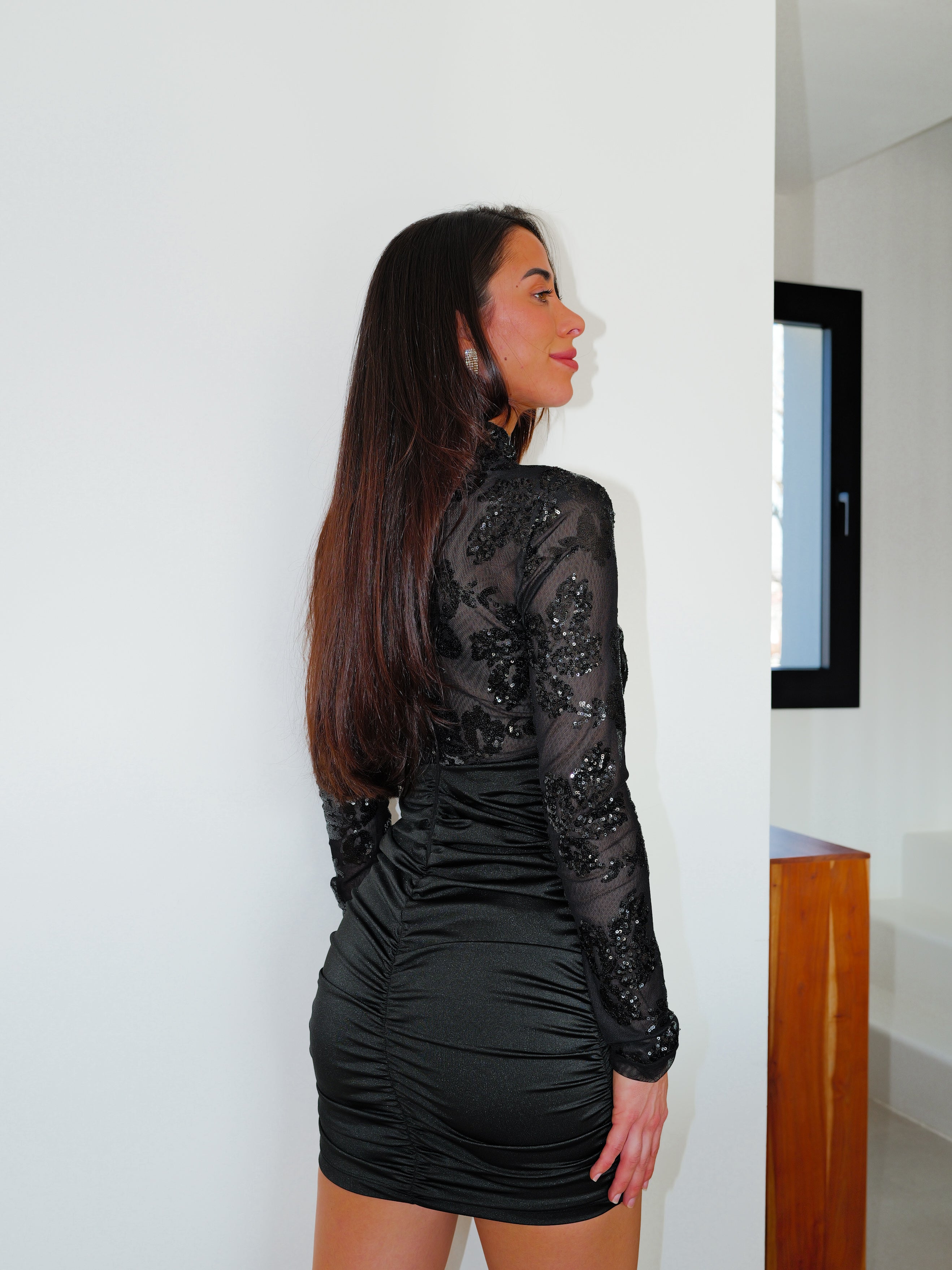 Black long-sleeved mini dress with details