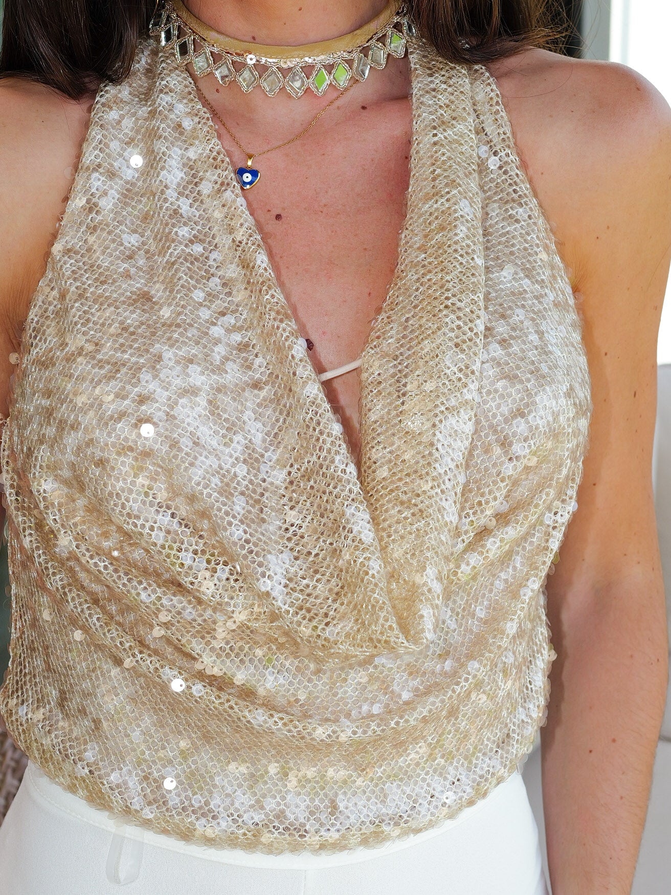 Top a cascata in paillettes dorate