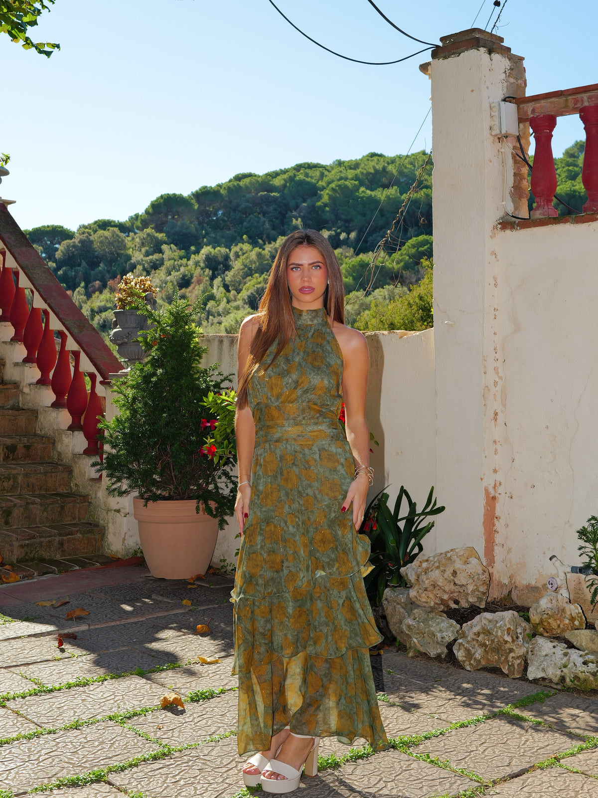 Olive-colored midi dress with a halter neckline and ruffles