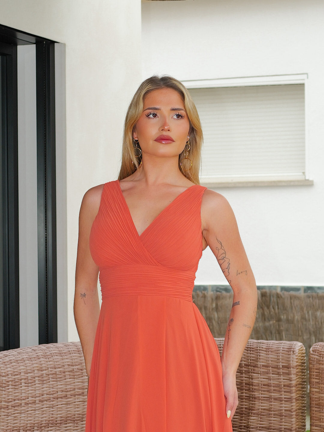 Long coral dress with draped V-neckline