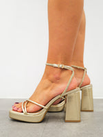 Golden shiny crossed sandal