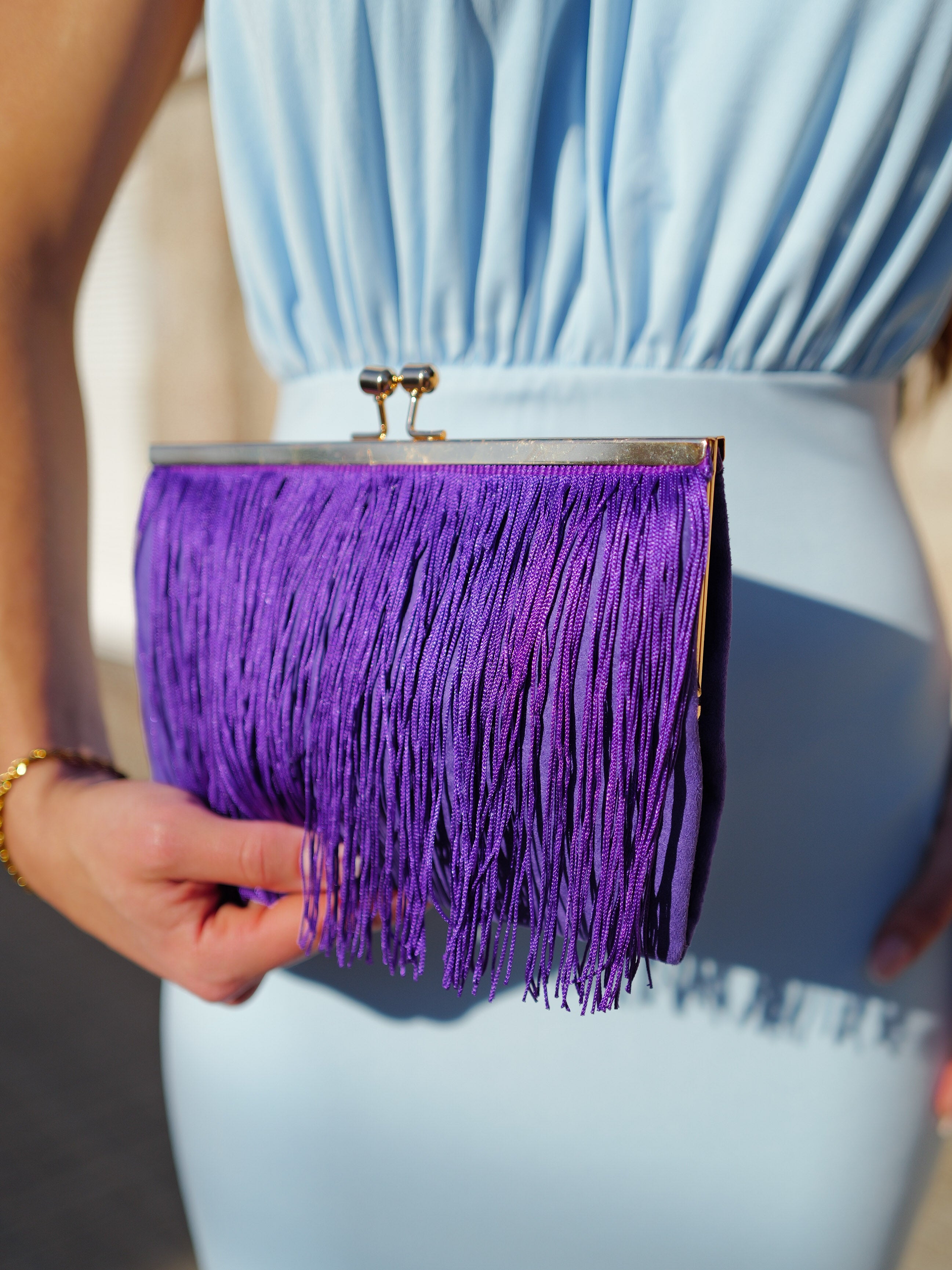 Purple fringed suede clutch