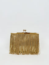 Gold fringed suede clutch