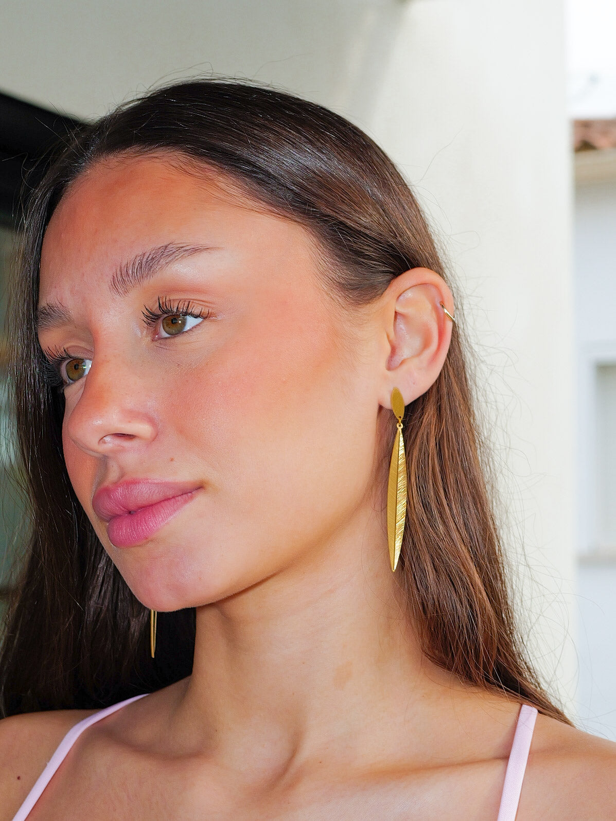 Long gold embossed earrings