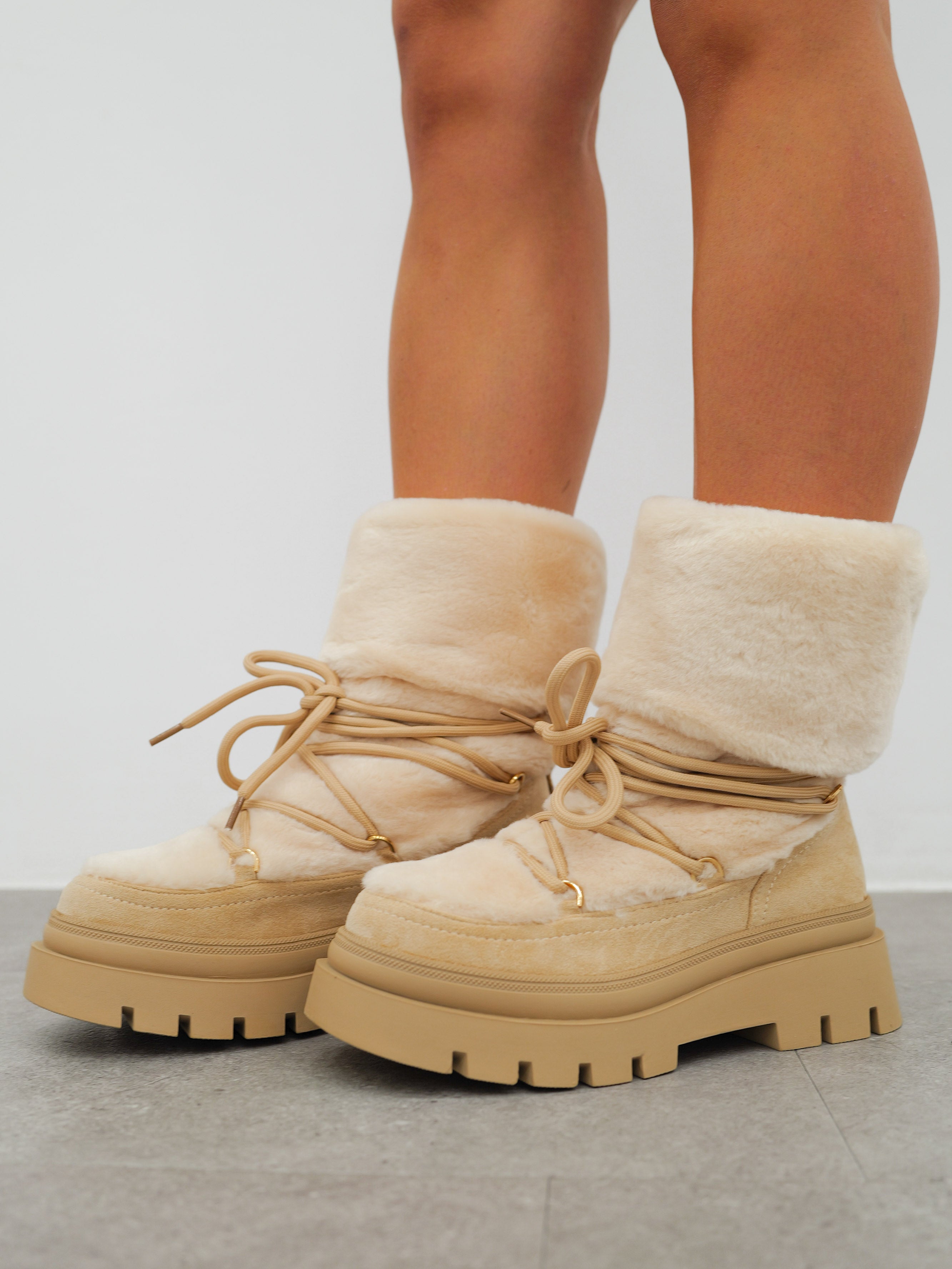 Beige furry ankle boots with laces detail