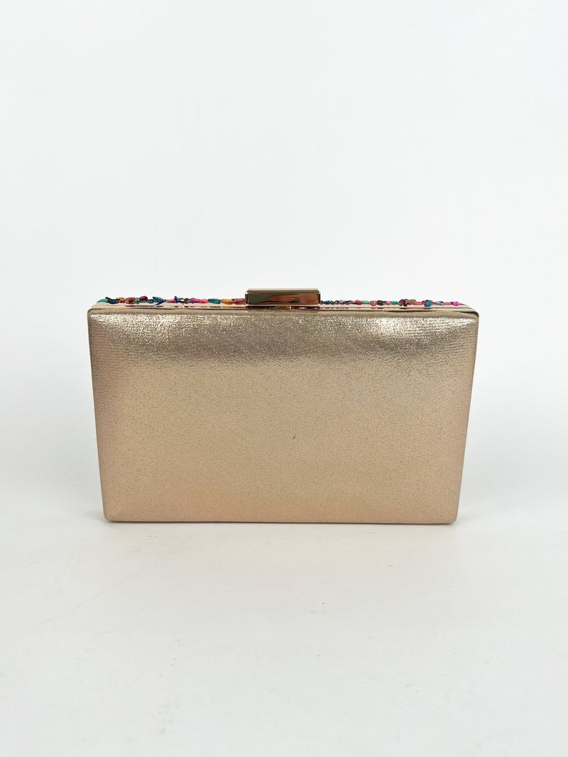 Pochette avec pierres dorées